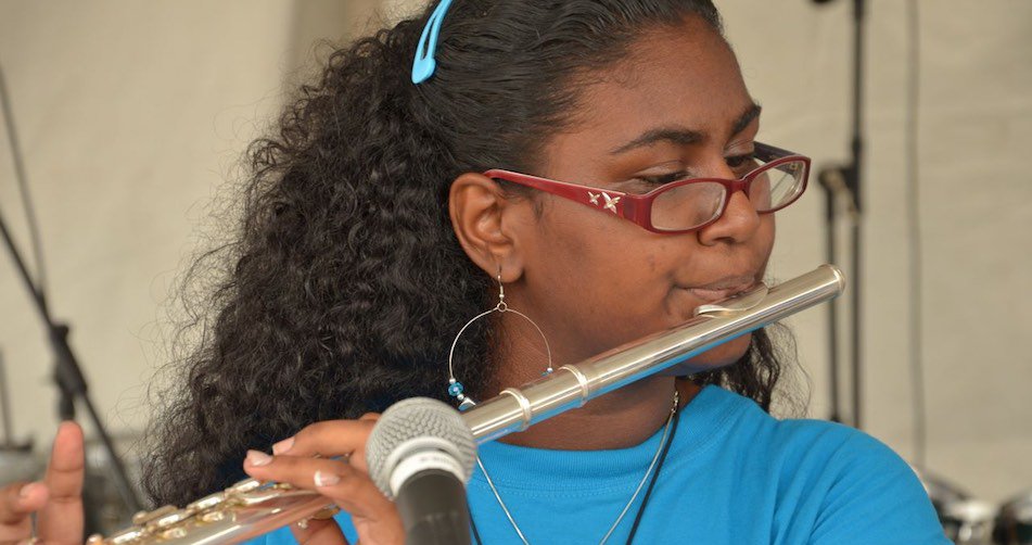 Birdsong After School Programme: Girl leaning to play flute
